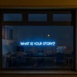 Neon Blue Sign That Reads What is Your Story?